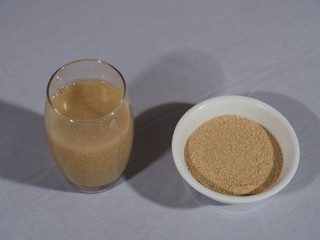 Fenugreek seeds on a wooden Background,Fenugreek Seeds or Methi Dana drink by soaking it in water...