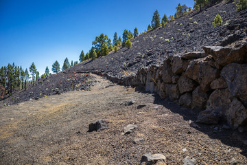 Mountainous rocky trail passing through frozen volcanic lava