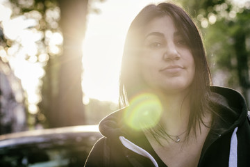 Portrait of a brunette girl with sunlight behind