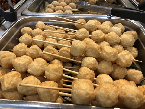 Close up of squid balls in skewers, a very popular street food in the Philippines.