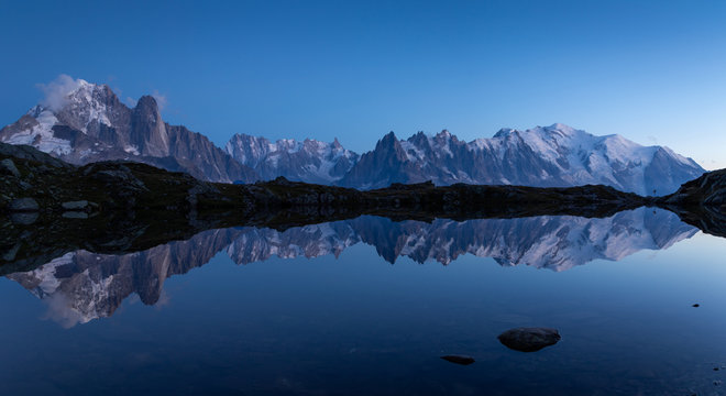 Panorama of the Alps near Chamonix, with Aiguille Verte, Les Drus, Auguille du Midi and Mont Blanc, during blue hour.