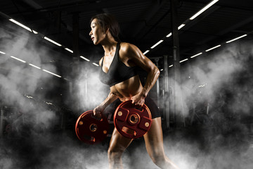 Women workout with disc barbell