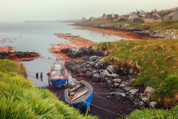 Small fishing boats on a foggy morning in Berneray, North Uist, Outer Hebrides, Scotland