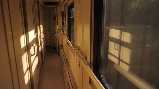 Interior of train railroad car sunlight compartment with night corridor before departure. slow motion video. Corridor of the compartment car of the new train. train lifestyle rail car from inside