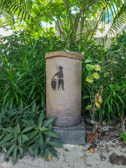 Trash can blending in on tropical island