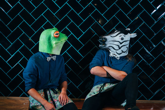 Unidentifiable people wears a White Rubber Zebra Horse and frog Head Mask  in a Photo Booth with black background. Stock Photo | Adobe Stock