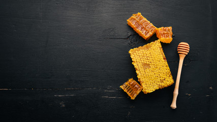Honey in honeycomb. On the old wooden background. Free space for text. Top view.