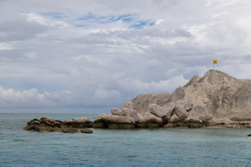 Mountain of sand with a flag on top