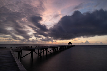 Long exposure sunset on jetty with hut