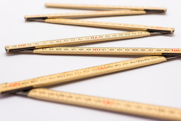 Wooden folding ruler isolated on a white background.
