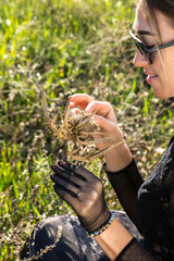 The girl in black with a dry flower