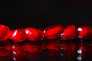 grains of pomegranate on a dark background