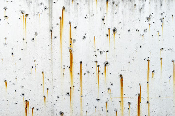 Rusty metal staining on white concrete surface