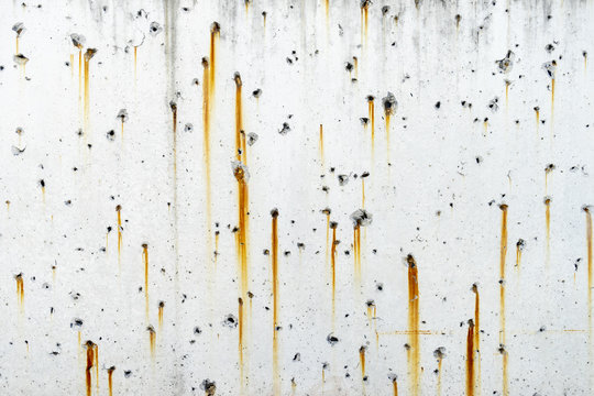 Rusty metal staining on white concrete surface