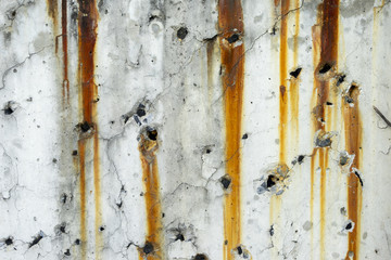 Rusty metal staining on white concrete surface