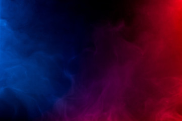 merging of colorful smoke on dark background