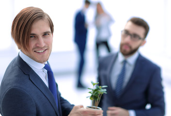 happy young businessman on the background of business partners