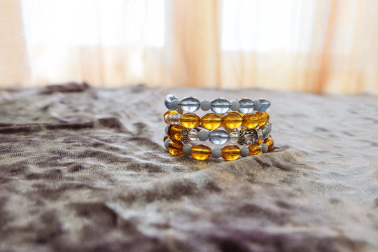 Handmade bracelet on a fabric surface. Limited depth of field.