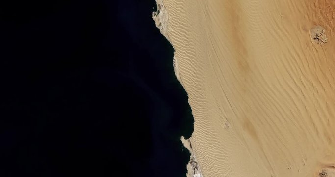 Very high-altitude overflight aerial of the west coast of Namibia. Clip loops and is reversible. Elements of this image furnished by USGS/NASA Landsat