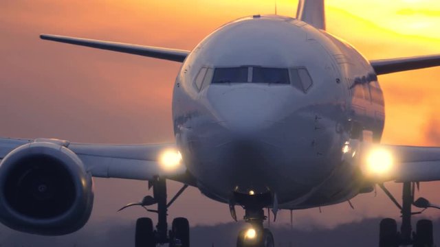 Airplane is taxiing on the taxiway before take off at sunset
