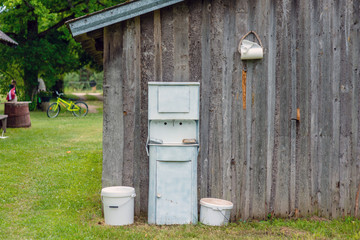 At the farmhouse outbuildings walls arranged Old fashioned rustic washstand.