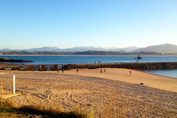 Old Stone Bridge on a Beach in Santander. Spain.