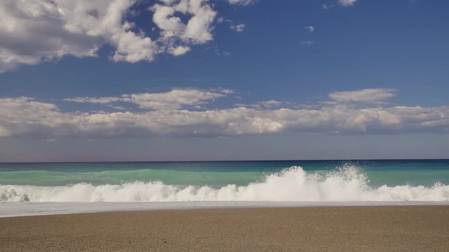 Beautiful waves on sandy beach on Sicili, Italy. Sunny day on the beach.