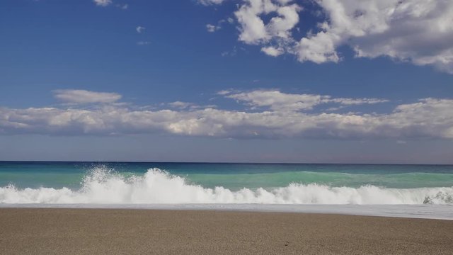 Beautiful waves on sandy beach on Sicili, Italy. Sunny day on the beach.