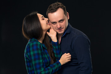 Woman whispering into a man's ear