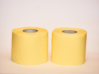 toilet paper, ywo tissue yellow paper rolls isolated on white background