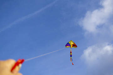 kite flying in a beautiful sky clouds. Focus on the kite