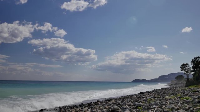 Beautiful waves on sandy beach on Sicili, Italy. Sunny day on the beach.