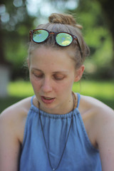 Portrait of a blonde girl on a green background. smiling girl 