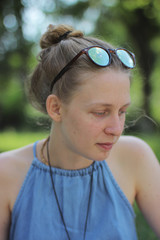 Portrait of a blonde girl on a green background. smiling girl 