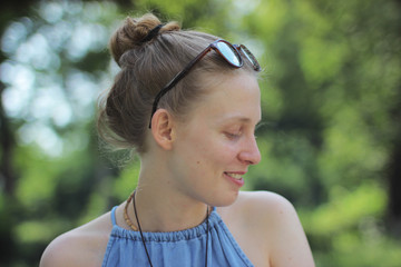 Portrait of a blonde girl on a green background. smiling girl 