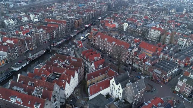 Aerial shot. High top view european city canals, roads, and streets between buildings with red tiled roof