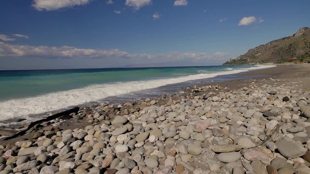 Beautiful waves on sandy beach on Sicili, Italy. Sunny day on the beach.