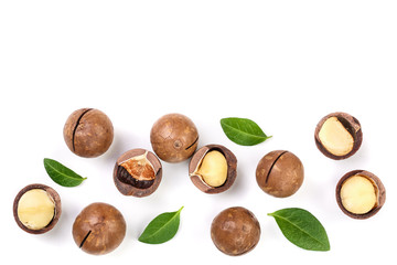 Shelled and unshelled macadamia nuts with leaves isolated on white background with copy space for your text. Top view. Flat lay pattern