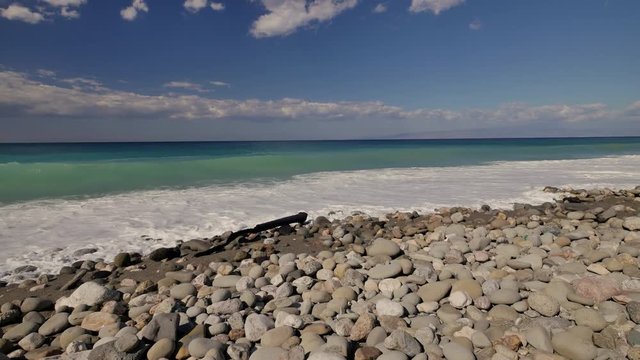 Beautiful waves on sandy beach on Sicili, Italy. Sunny day on the beach.