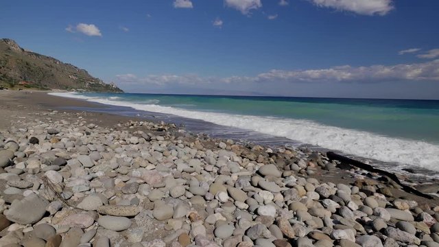 Beautiful waves on sandy beach on Sicili, Italy. Sunny day on the beach.