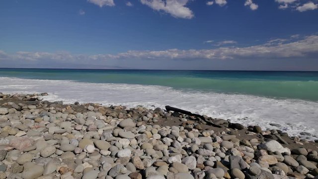 Beautiful waves on sandy beach on Sicili, Italy. Sunny day on the beach.