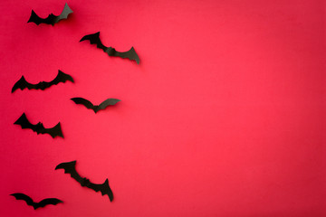 Flying bats on red background