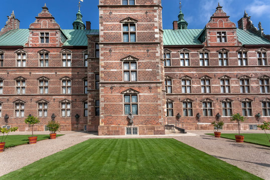 Brick walls and green lawn of Rosenborg Castle, built in 17th century. Historical landmarks of Copenhagen, Denmark