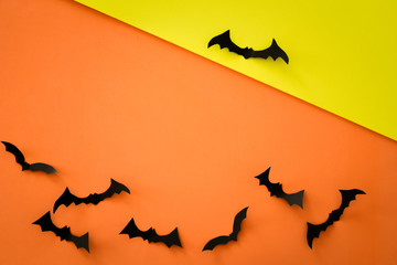 Flying bats on orange background