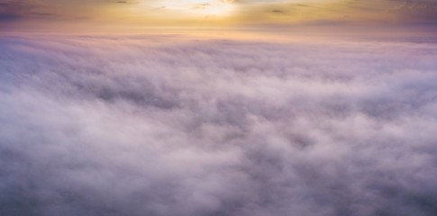 Beautiful foggy sunrise panoramic landscape from drone.