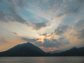 A scenic cloudy sunset in the alpine hills above Lake Como, Lombardy, northern Italy.