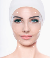 Face of beautiful woman with perfect skin , with lifting arrows on face, concept of facial surgery...