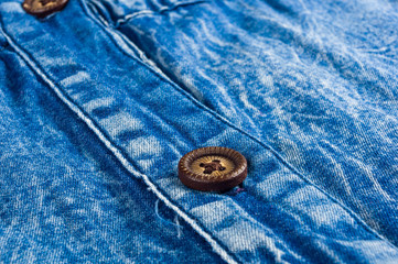 Blue washed faded jeans texture with seams, clasps, buttons and rivets