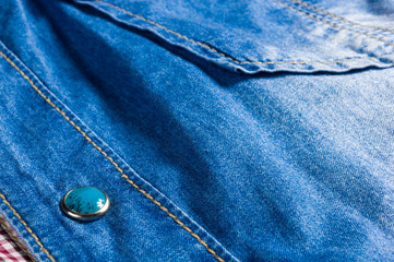 Blue washed faded jeans texture with seams, clasps, buttons and rivets