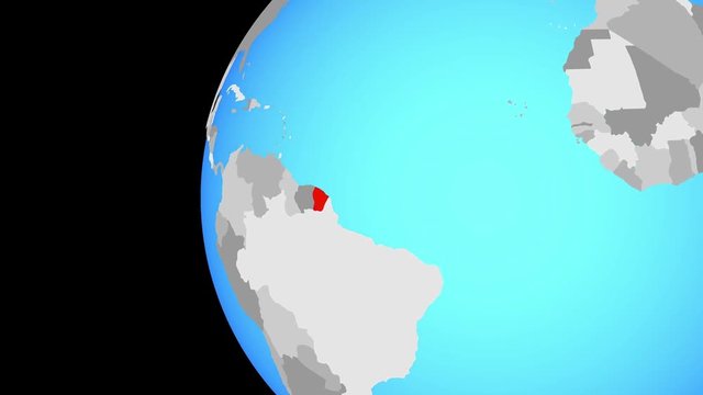 French Guiana on blue political globe. Orbiting around globe and zooming to the country. 3D illustration.